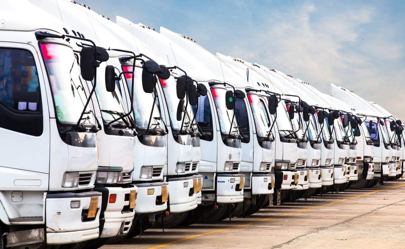 A fleet of trucks lined up on the tarmac