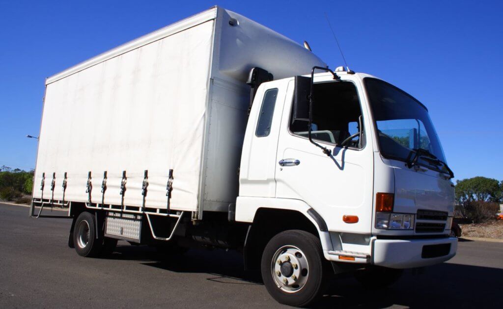 A white rigid truck on the road