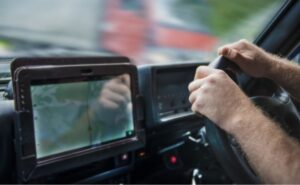truck driver in cockpit with gps