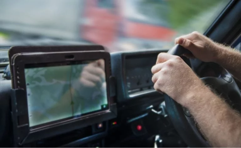 truck driver in cockpit with gps